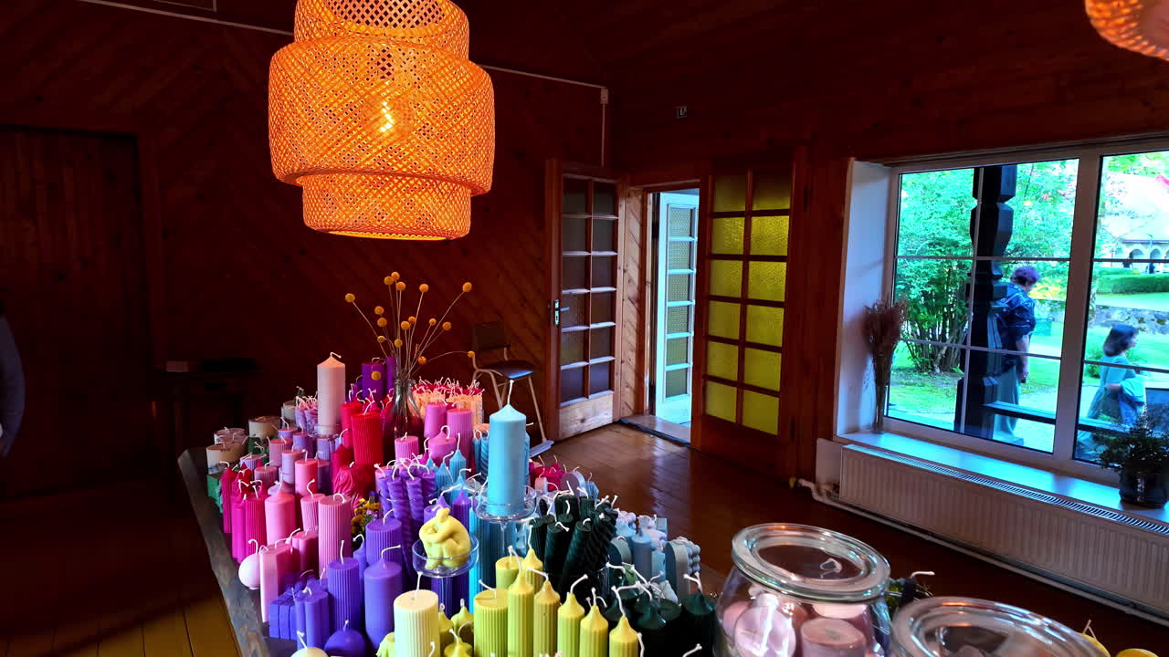 Handmade candles for sale in boutique store, slow motion view