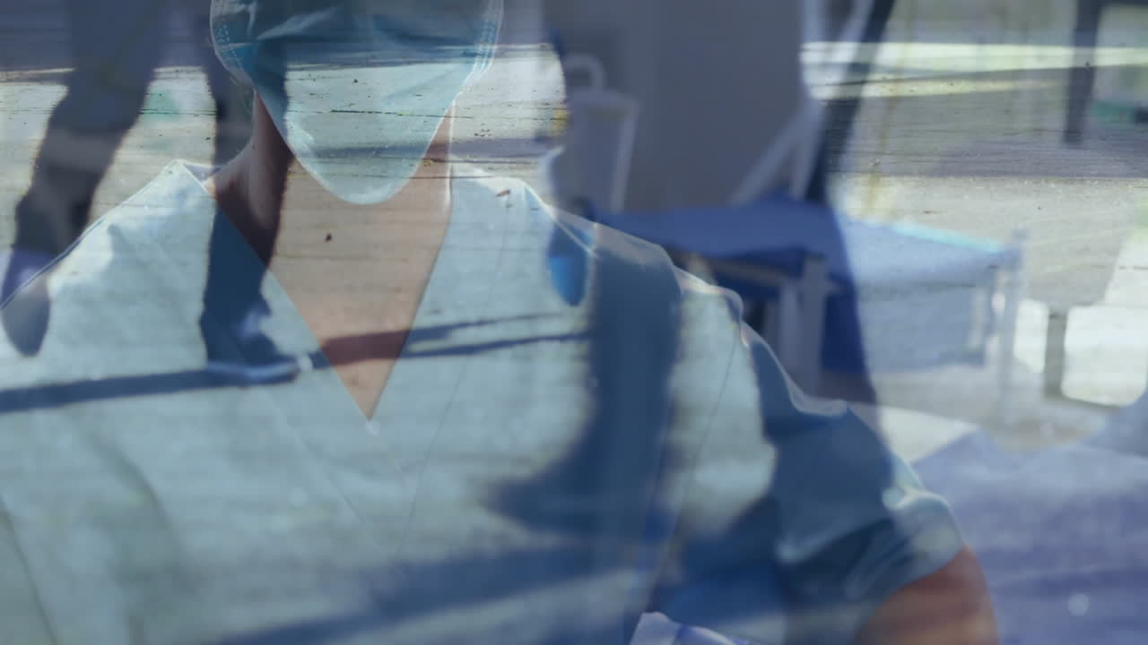 Medical professional wearing scrubs and mask over ocean waves animation