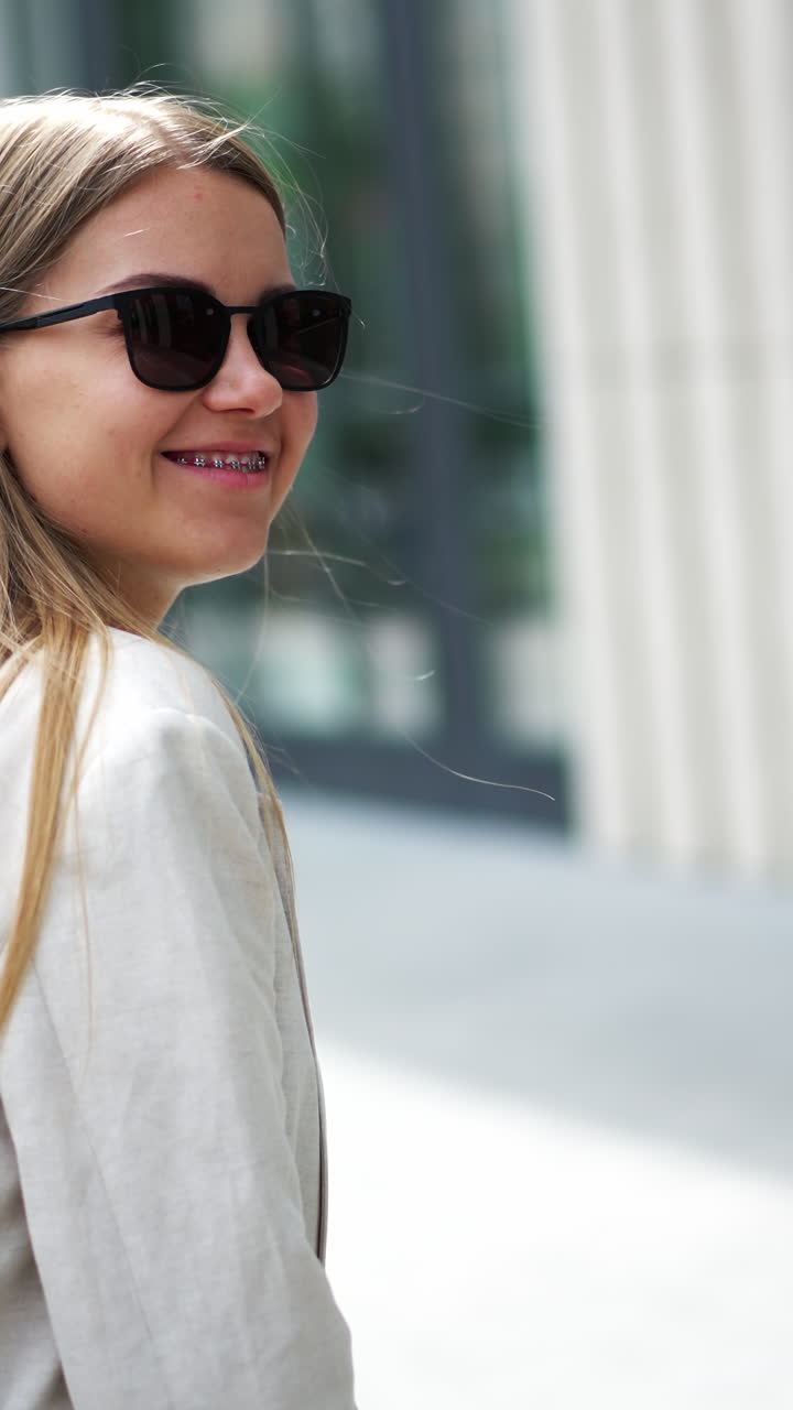 Portrait of confident young lady in lifestyle cloth. Young pretty businesswoman outdoor. Vertical video