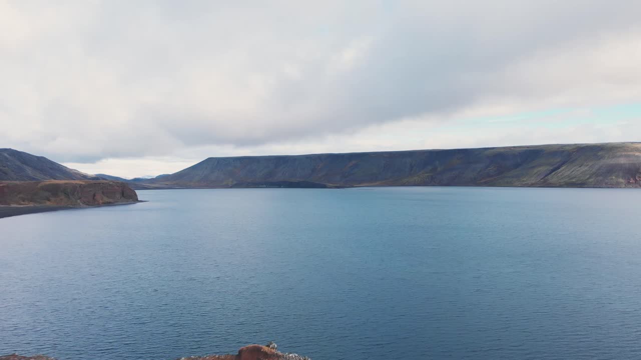 Rocky cliffs and mountains around Kleifarvatn lake in Iceland, drone.