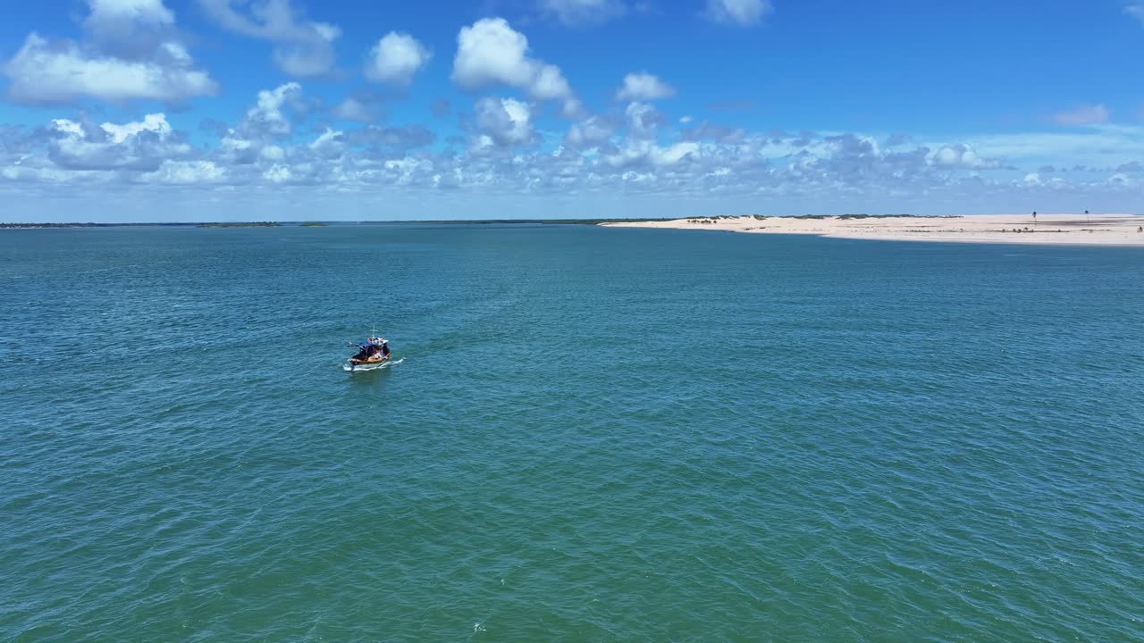 on a fishing boat sailing at the mouth of the São Francisco River where the freshwater river meets the Atlantic Ocean.