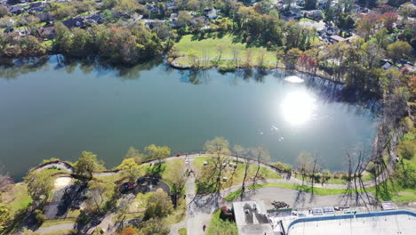 a drone view over grant pond in a long island, ny suburb