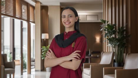 Portrait-of-Happy-Indian-female-housekeeper-standing-crossed-hands