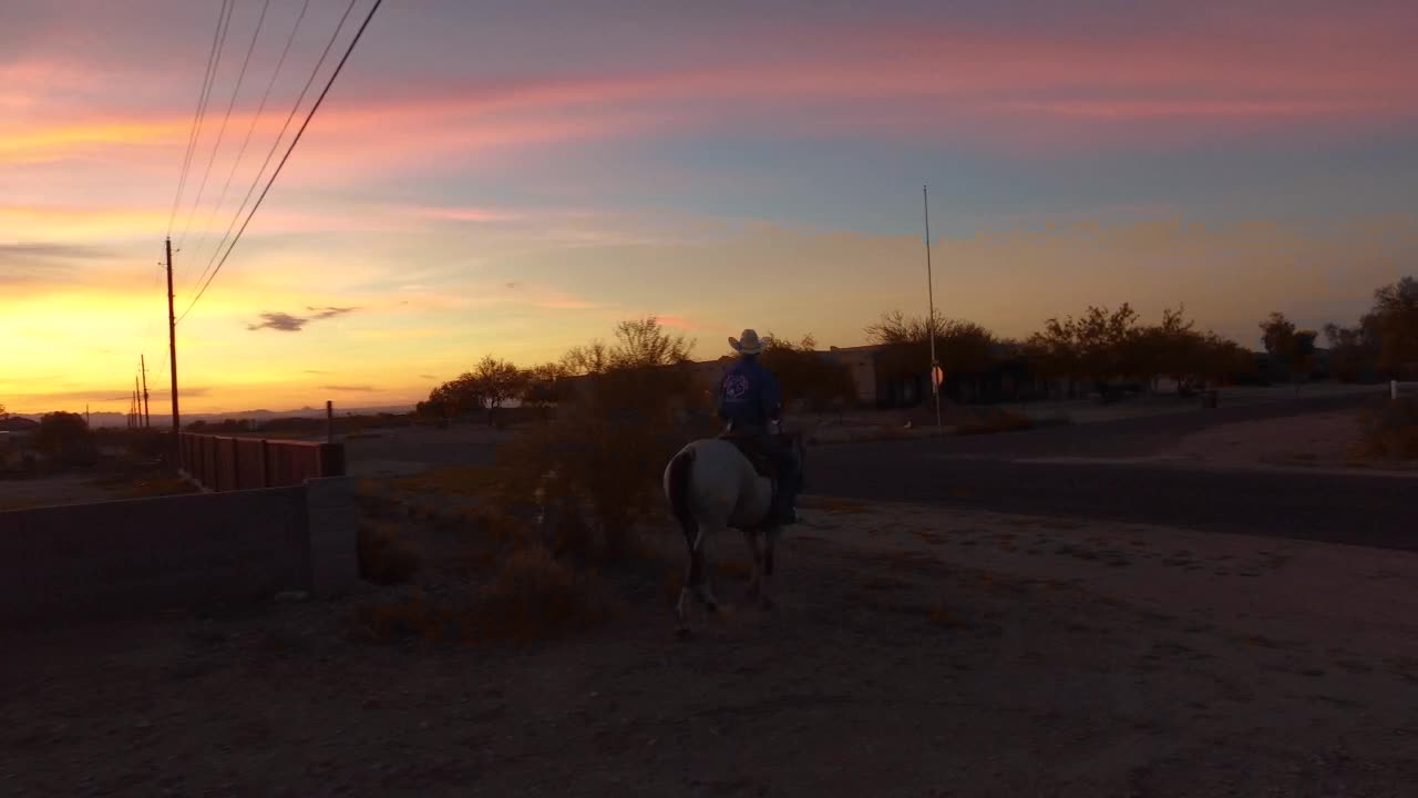 Cowboy and Horseback Rider Silhouette at Sunset