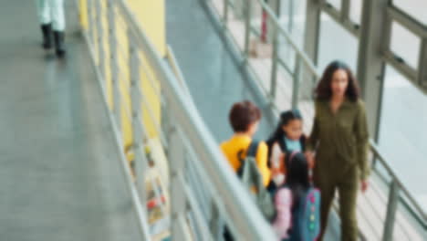 mother walking with her child in a school hallway