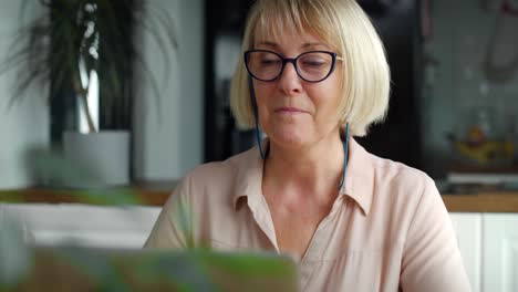 video of happy senior woman during video conference at home