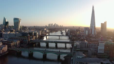 establishing aerial drone dolly back shot of thames river london city centre sunrise