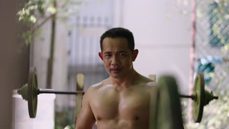 shirtless man sweating during workout