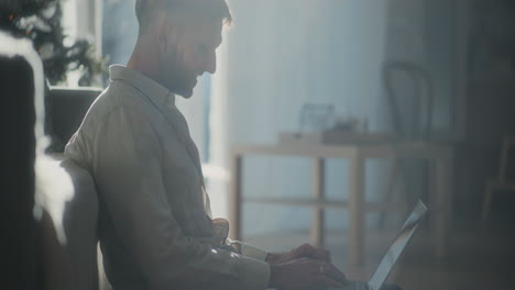 silhouette of man working on laptop works remotely from home