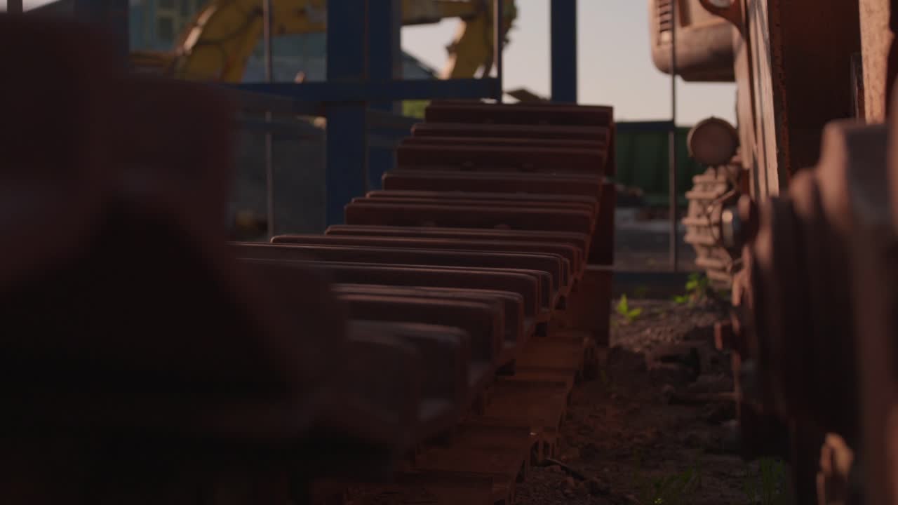 rusty belts from the bulldozer at the scrap yard on golden hour