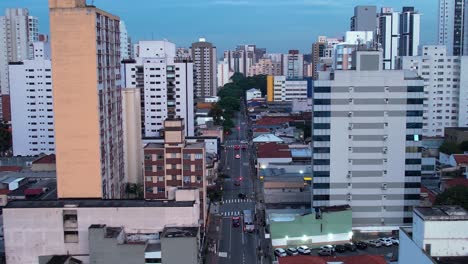 ascending aerial view of traffic on a quiet street in sao paulo, evening in brazil