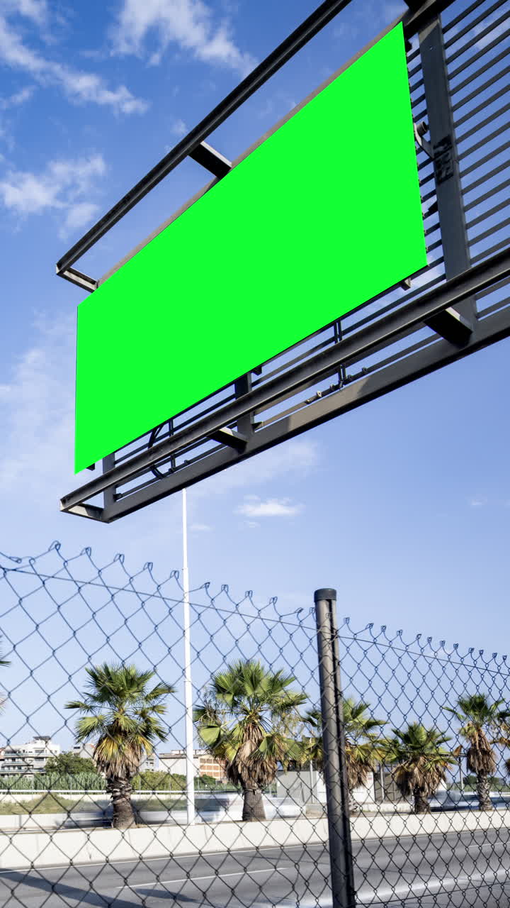 Rush of traffic on highway in city with green screen on the overhead video