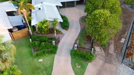 aerial drone overview of a house on a golf course, surrounded by green fairways and scenic landscapes