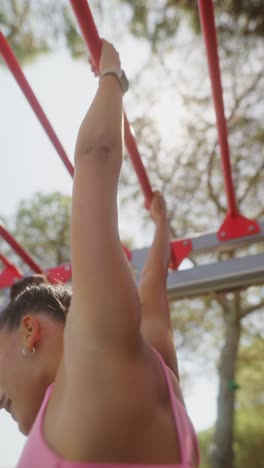 woman exercising on outdoor monkey bars