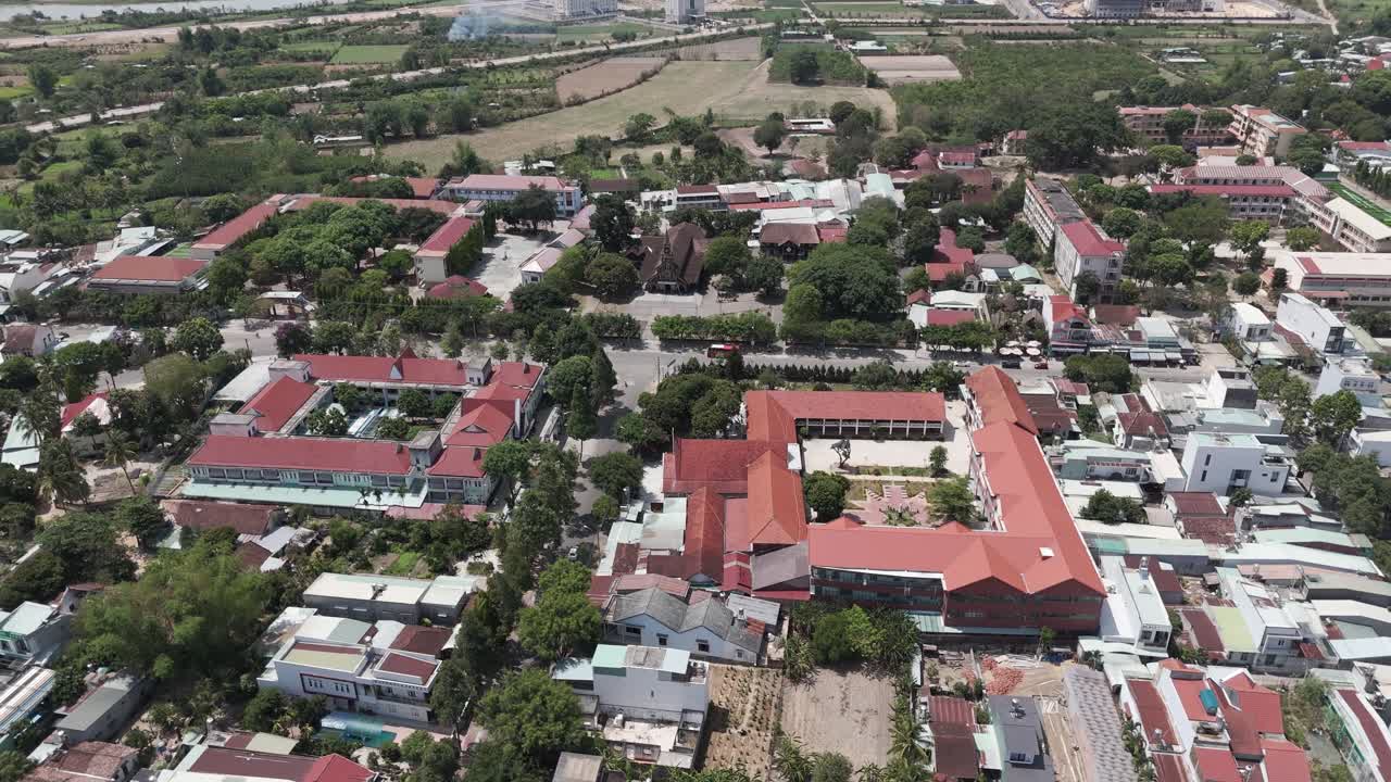 Aerial drone view above Kon Tum city in the highlands of Vietnam. Footage above the old quarter and the famous wooden cathedral