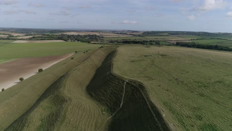 Aerial-tracking-down-between-the-outer-ramparts-of-the-iron-age-hill-fort-of-Maiden-Castle