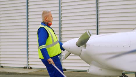 male engineer pulling an aircraft 4k