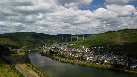 Flight-sideways-over-a-village-next-to-Moselle-and-vineyard