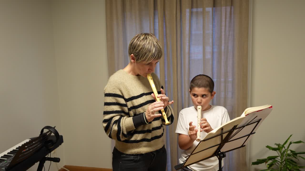 Adult Woman and Boy Playing Recorders from Sheet Music