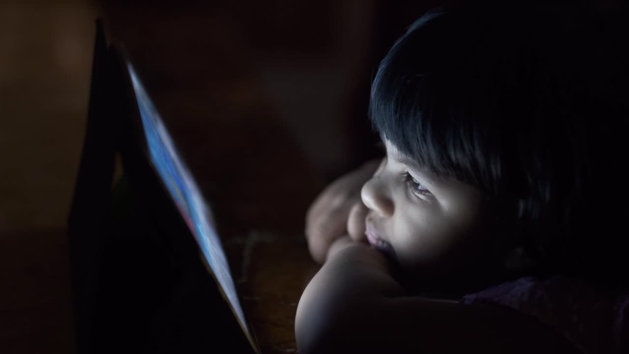 밤에 태블릿을 사용하는 아이