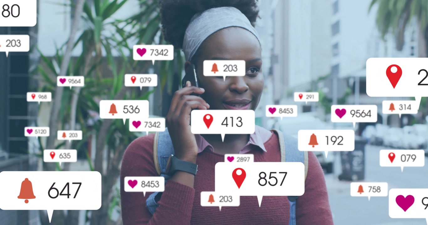 Animation of social media notifications over happy african american woman talking on smartphone