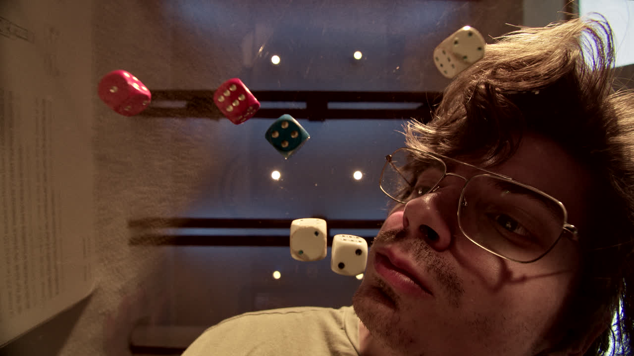 Man looking up at scattered dice