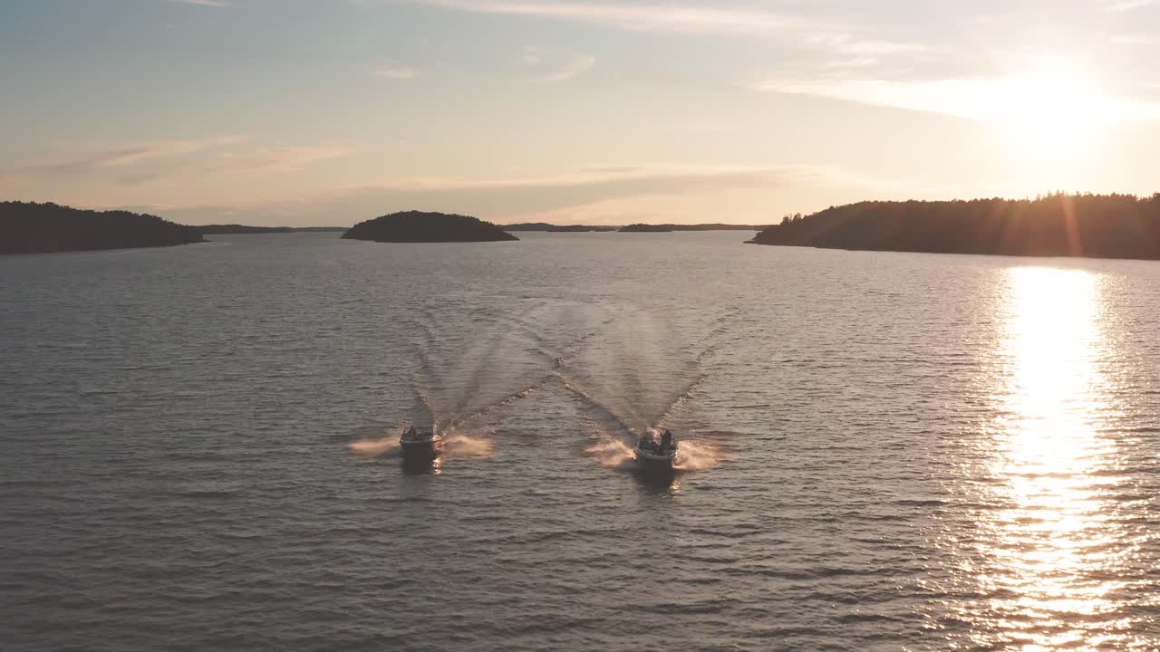 High speed boat chase from the front angle - contrast between setting sun and the archipelago.