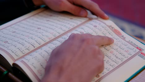 close up of hands on quran in mosque 1