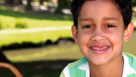 portrait of smiling boy in park