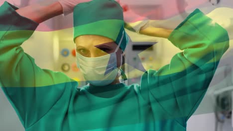 Animation-of-flag-of-ghana-waving-over-surgeons-in-operating-theatre