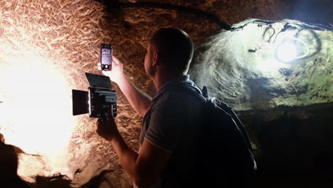 tourist with a backpack in the cave speleology cave dungeon tourist with a backpack in the cave speleology cave dungeon dark tunnel underground excavations