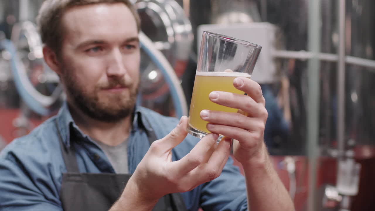 Brewery Worker Inspecting Freshly Made Beer