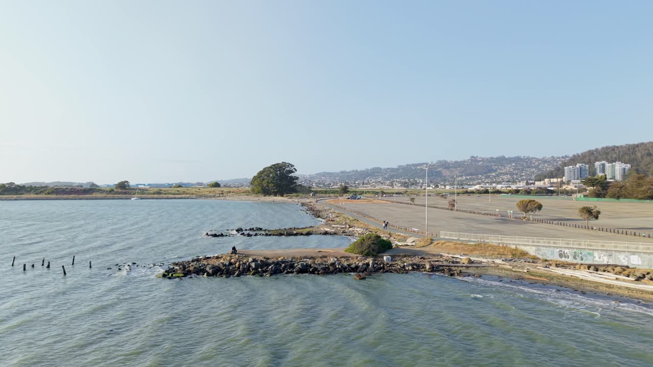 The drone glides over Albany’s serene shoreline, tracing paths carved by wind and time along the coast.
