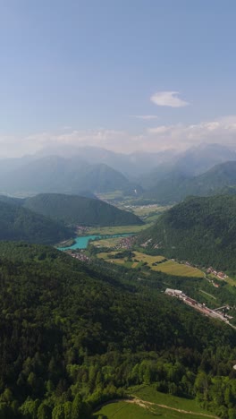 vertical aerial view of tolmin and most na soči villages in slovenia’s posočje valley with blue water