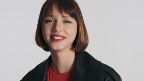 stylish model smiling on camera in studio