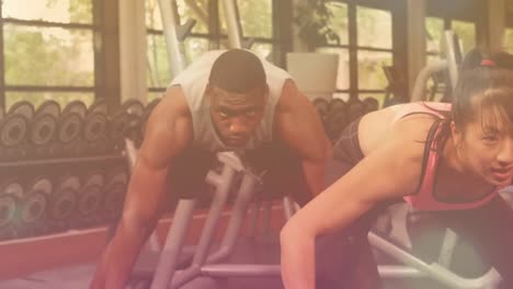 animation of light spots over diverse people exercising at gym