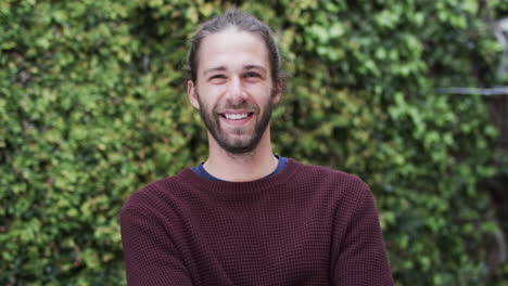 Portrait-of-happy-caucasian-man-wearing-red-jumper-in-garden,-slow-motion