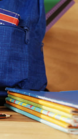 close-up of school bag with books and spectacles