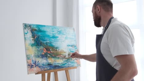 super slow motion 240 fps the artist paints an abstract picture in the studio - super slow motion 240 fps, the artist paints an abstract picture in the studio. a modern artist paints an emotional, sensual oil painting
