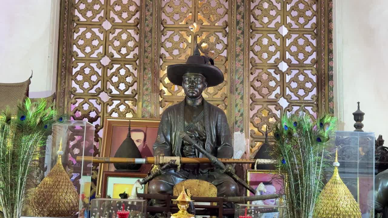 Bangkok statue of man in buddhist temple with celebration decorations