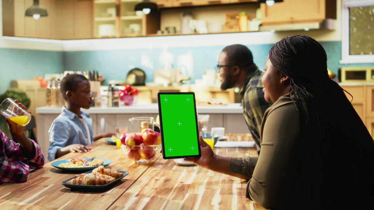 Family using a tablet during breakfast