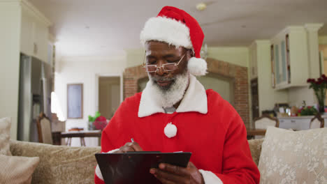 senior african american man wearing santa costume at christmas time