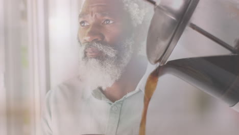 animation of coffee over african american man holding mug and drinking, slow motion