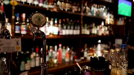 bartender pouring a drink in a lively bar setting