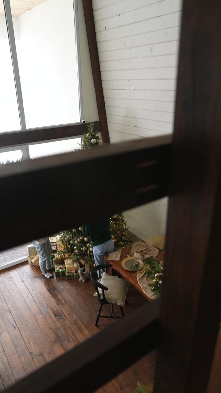 Family decorating a Christmas Tree in a cozy cabin