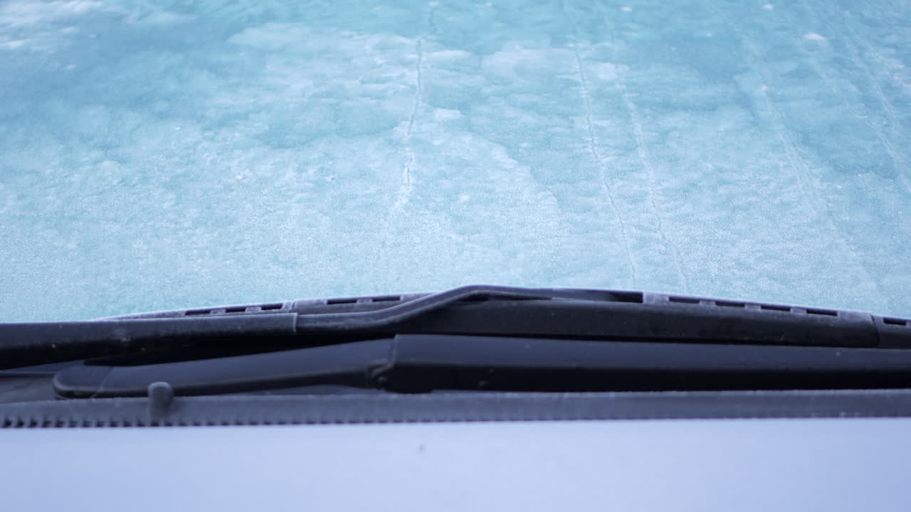 Frozen ice on a car window on a frosty morning