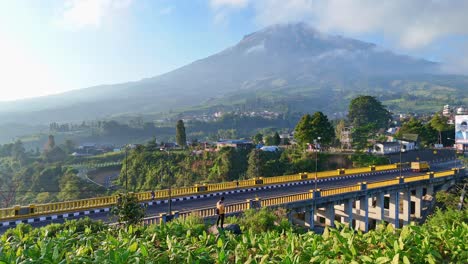 vehicles crossing sigandul bridge in tropical indonesia at sunset