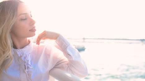 slow motion:beautiful girl enjoys moment while cruising with view of sea on background