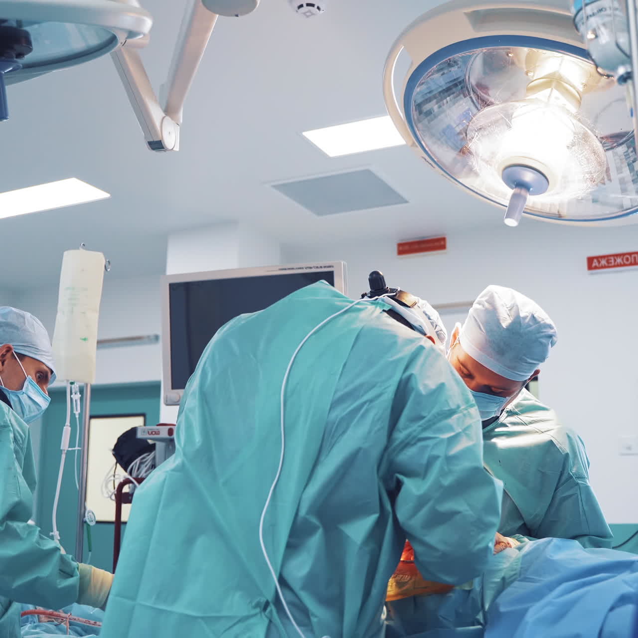 Contemporary equipment in operating room. Group of surgeons performing an operation in medical clinic. Neurosurgery.