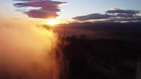 Fly-near-the-clouds-on-Sanctuary-of-Bellmunt-in-Spain-at-sunset-in-the-Pyrenees-mountains